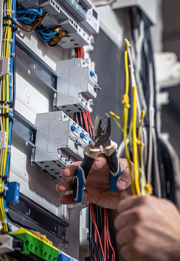 Electrician works in a switchboard