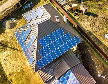 Aerial view of a modern house with solar panels installed
