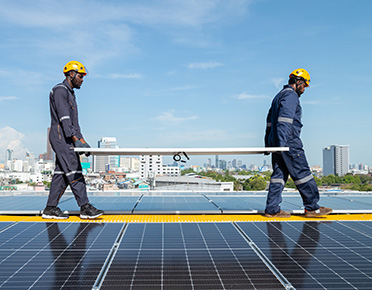 Workers implementing a solar on rooftop
