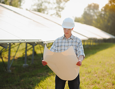 Worker at a solar power plant reading a plan